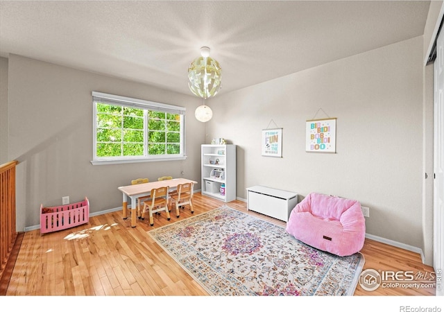 13445 Kearney St, Thornton, CO 80602 - recreation room with wood finished floors and baseboards