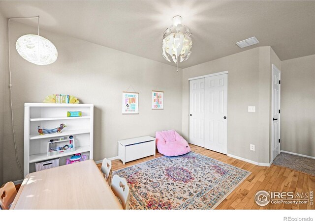 13445 Kearney St, Thornton, CO 80602 - bedroom with wood finished floors, baseboards, a closet, and a chandelier