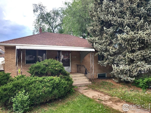 1617 Remington St, Fort Collins, CO 80525 - view of front of property featuring brick siding and roof with shingles