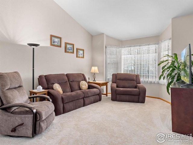 1536 Goshawk Dr, Longmont, CO 80504 - living area with carpet floors, vaulted ceiling, and baseboards