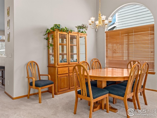 1536 Goshawk Dr, Longmont, CO 80504 - dining area featuring a chandelier, light carpet, and baseboards