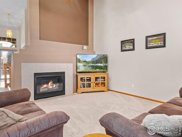 1536 Goshawk Dr, Longmont, CO 80504 - living area featuring carpet floors, a fireplace, baseboards, and a high ceiling