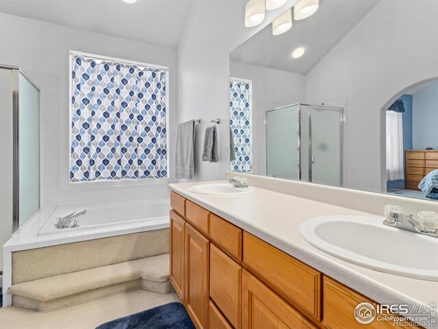 1536 Goshawk Dr, Longmont, CO 80504 - bathroom with a shower stall, double vanity, a bath, lofted ceiling, and ensuite bath