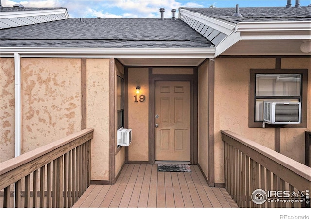 225 E 8th Ave Unit C-19, Longmont, CO 80504 - property entrance featuring roof with shingles, stucco siding, and cooling unit