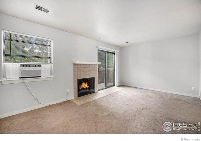 225 E 8th Ave Unit C-19, Longmont, CO 80504 - unfurnished living room with a tile fireplace, carpet flooring, baseboards, and cooling unit