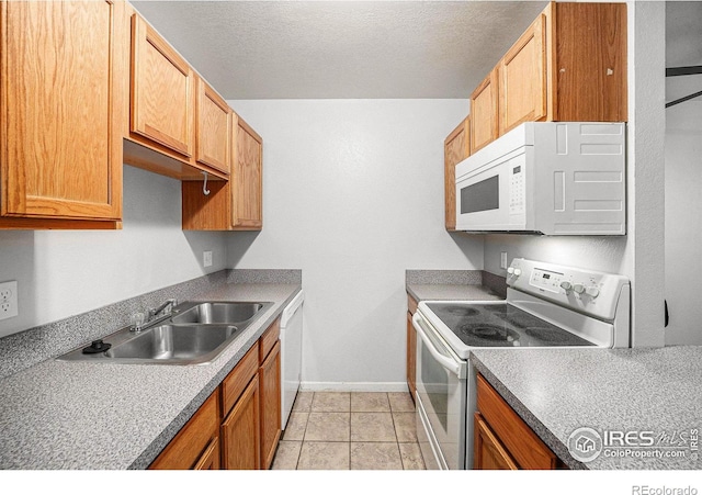 225 E 8th Ave Unit C-19, Longmont, CO 80504 - kitchen featuring white appliances, a sink, baseboards, and a textured ceiling