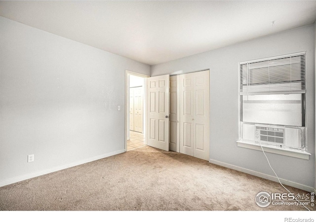 225 E 8th Ave Unit C-19, Longmont, CO 80504 - unfurnished bedroom featuring carpet floors, baseboards, and cooling unit