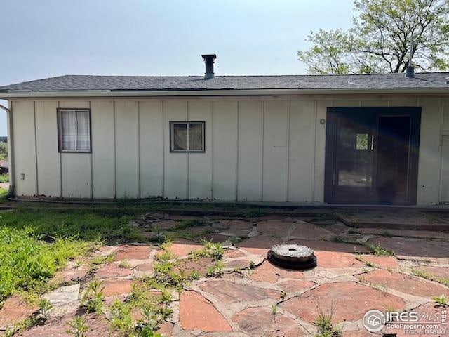 4809 Foothills Dr, Fort Collins, CO 80526 - view of property exterior featuring board and batten siding, a patio area, and a shingled roof
