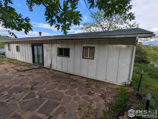 4809 Foothills Dr, Fort Collins, CO 80526 - rear view of property featuring board and batten siding, a patio, and roof with shingles