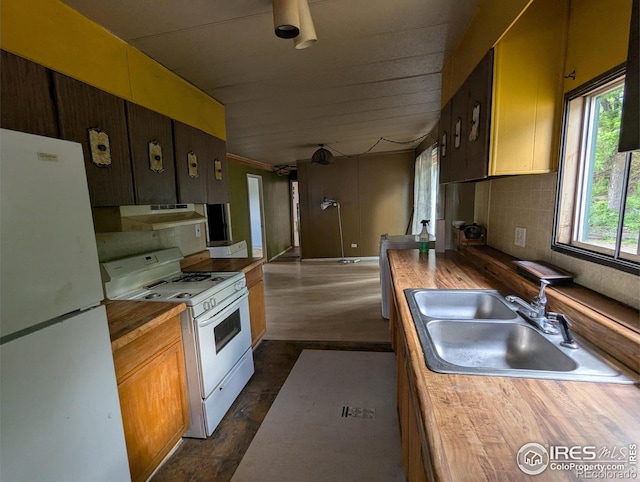 4809 Foothills Dr, Fort Collins, CO 80526 - kitchen with white appliances, wood counters, a sink, backsplash, and under cabinet range hood