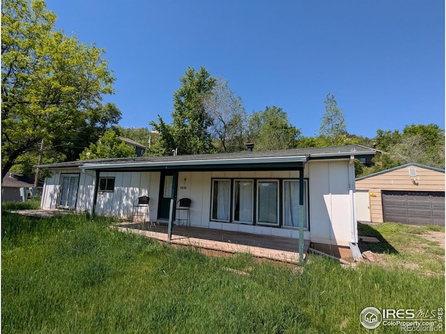 4809 Foothills Dr, Fort Collins, CO 80526 - back of house with a yard, a detached garage, and an outdoor structure