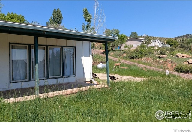 4809 Foothills Dr, Fort Collins, CO 80526 - view of home's exterior with a lawn
