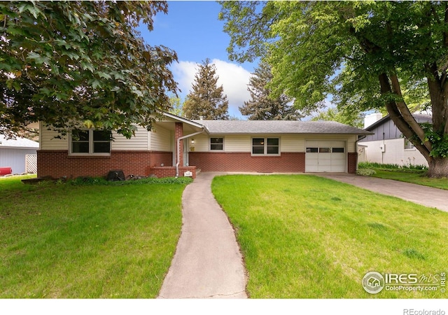1409 Welch St, Fort Collins, CO 80524 - view of front facade featuring brick siding, an attached garage, concrete driveway, and a front lawn