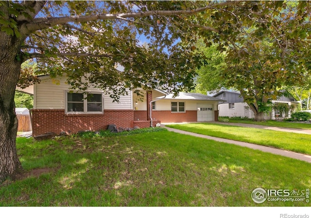 1409 Welch St, Fort Collins, CO 80524 - view of front of property featuring brick siding, a garage, a front lawn, and concrete driveway