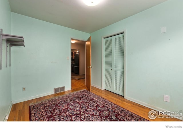 1409 Welch St, Fort Collins, CO 80524 - unfurnished bedroom featuring wood finished floors, a closet, and baseboards