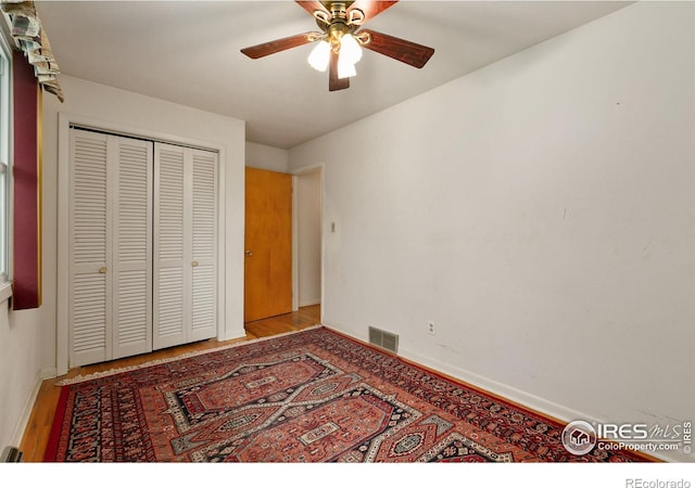 1409 Welch St, Fort Collins, CO 80524 - unfurnished bedroom with wood finished floors, baseboards, a closet, and a ceiling fan