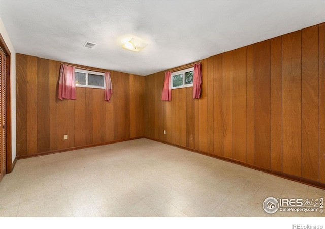 1409 Welch St, Fort Collins, CO 80524 - basement with wooden walls and tile patterned floors