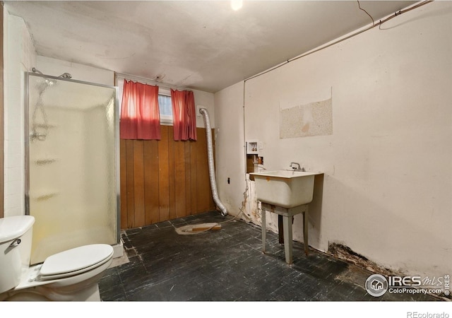 1409 Welch St, Fort Collins, CO 80524 - bathroom with a stall shower, toilet, and wood walls