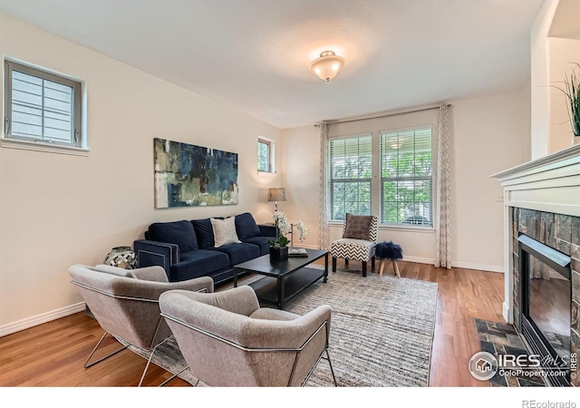 634 Homestead St, Lafayette, CO 80026 - living room with wood finished floors, baseboards, and a tile fireplace