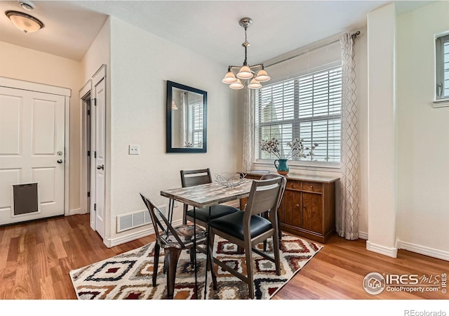 634 Homestead St, Lafayette, CO 80026 - dining area with a chandelier, healthy amount of natural light, and light wood-type flooring