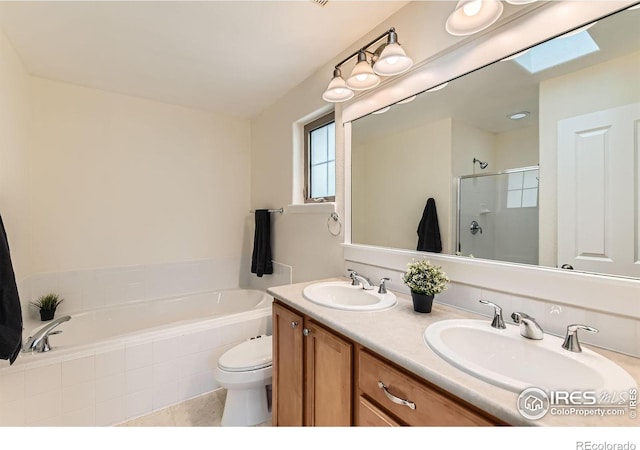 634 Homestead St, Lafayette, CO 80026 - bathroom with a garden tub, a stall shower, double vanity, toilet, and a skylight