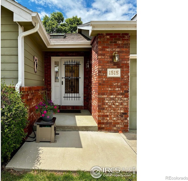 1515 Tulip Ct, Longmont, CO 80501 - doorway to property featuring brick siding