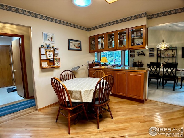 1515 Tulip Ct, Longmont, CO 80501 - dining area with light wood-style flooring, a chandelier, and baseboards