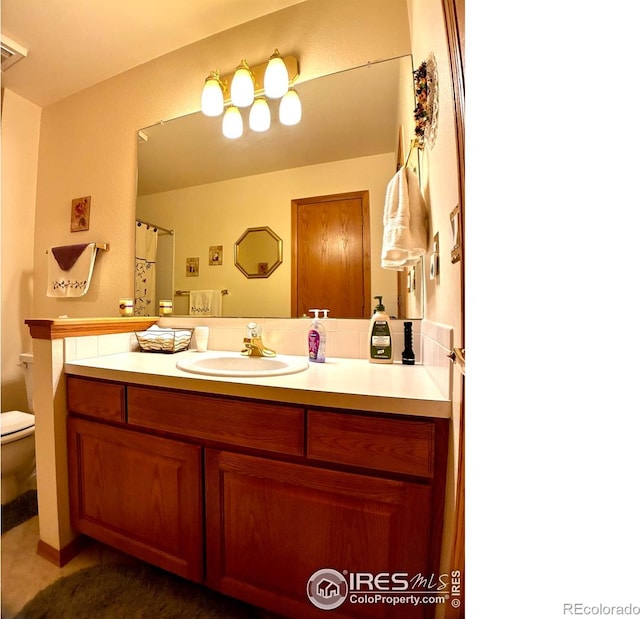1515 Tulip Ct, Longmont, CO 80501 - bathroom featuring toilet, vanity, and tile patterned flooring