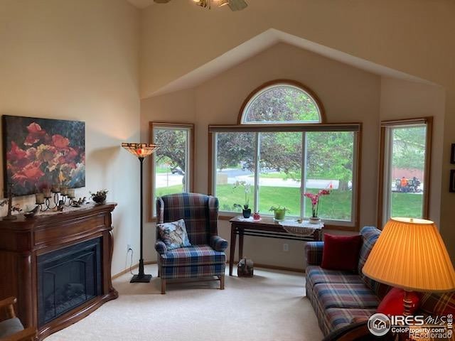 1515 Tulip Ct, Longmont, CO 80501 - living area with plenty of natural light, carpet flooring, vaulted ceiling, and a glass covered fireplace