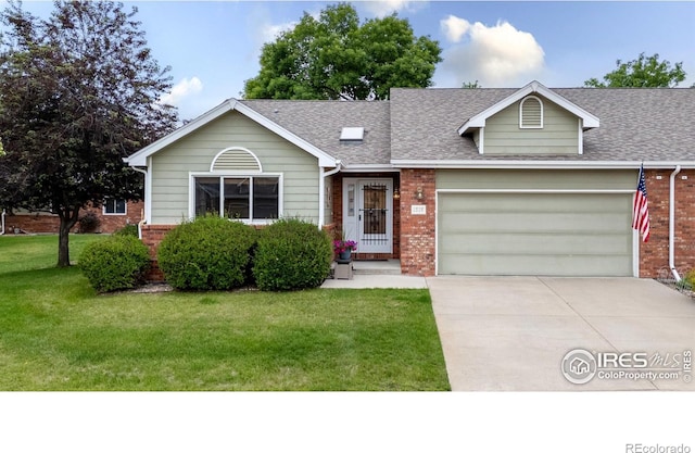 1515 Tulip Ct, Longmont, CO 80501 - view of front facade featuring brick siding, an attached garage, a front lawn, roof with shingles, and driveway