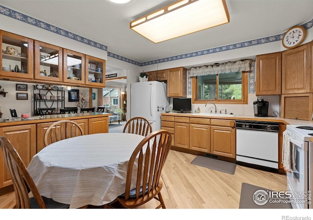 1515 Tulip Ct, Longmont, CO 80501 - kitchen featuring white appliances, light wood finished floors, a sink, glass insert cabinets, and light countertops