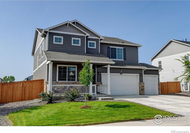 3657 Speedwell St, Wellington, CO 80549 - craftsman-style house with a porch, driveway, stone siding, an attached garage, and roof with shingles
