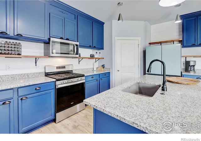 3657 Speedwell St, Wellington, CO 80549 - kitchen with appliances with stainless steel finishes, open shelves, blue cabinets, and light wood-style floors