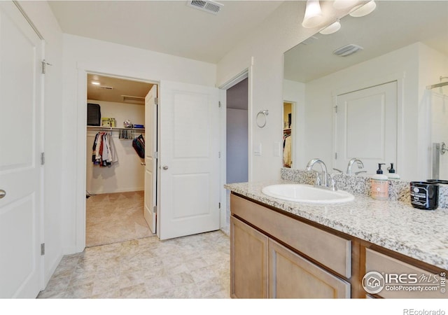 3657 Speedwell St, Wellington, CO 80549 - bathroom with vanity and a walk in closet