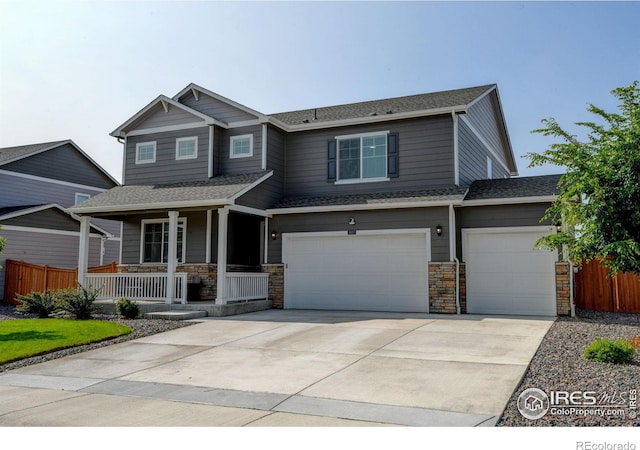 3657 Speedwell St, Wellington, CO 80549 - craftsman-style home with a porch, driveway, stone siding, and a shingled roof