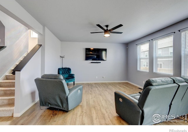 3657 Speedwell St, Wellington, CO 80549 - living area with wood finished floors, a ceiling fan, and stairway