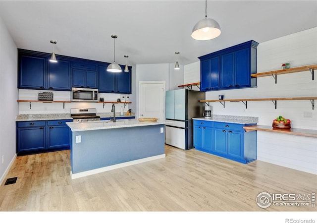 3657 Speedwell St, Wellington, CO 80549 - kitchen with appliances with stainless steel finishes, blue cabinetry, open shelves, light wood-type flooring, and decorative light fixtures