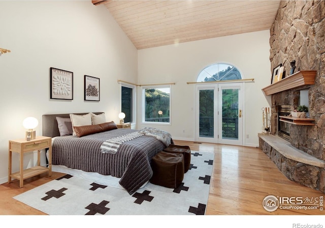 142 Meadowlook Way, Boulder, CO 80304 - bedroom featuring access to exterior, high vaulted ceiling, light wood-style flooring, wooden ceiling with exposed beams, and a fireplace