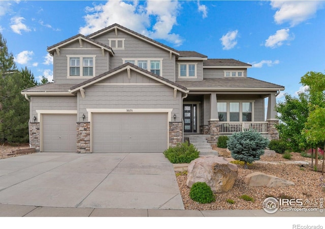 3075 Blue Mountain Dr, Broomfield, CO 80023 - craftsman-style house featuring concrete driveway, a porch, an attached garage, and stone siding