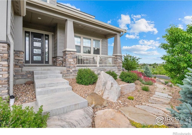 3075 Blue Mountain Dr, Broomfield, CO 80023 - view of exterior entry with a porch and stone siding