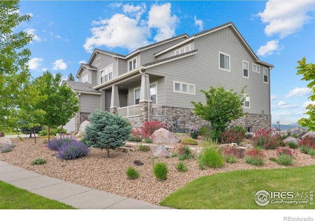 3075 Blue Mountain Dr, Broomfield, CO 80023 - view of side of home featuring stone siding and a porch