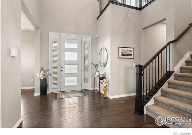 3075 Blue Mountain Dr, Broomfield, CO 80023 - foyer entrance with wood finished floors, a high ceiling, baseboards, and stairs