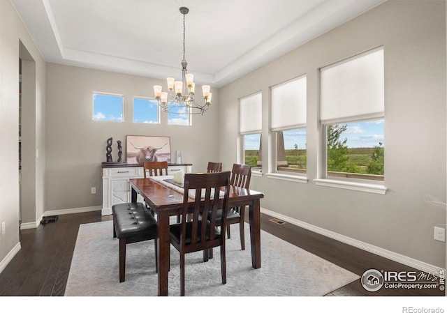 3075 Blue Mountain Dr, Broomfield, CO 80023 - dining room with a chandelier, baseboards, dark wood finished floors, and a tray ceiling