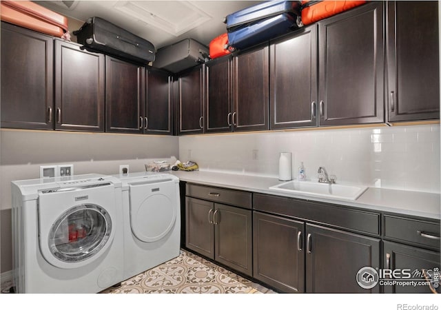 3075 Blue Mountain Dr, Broomfield, CO 80023 - laundry area with cabinet space, washer and clothes dryer, and light tile patterned floors