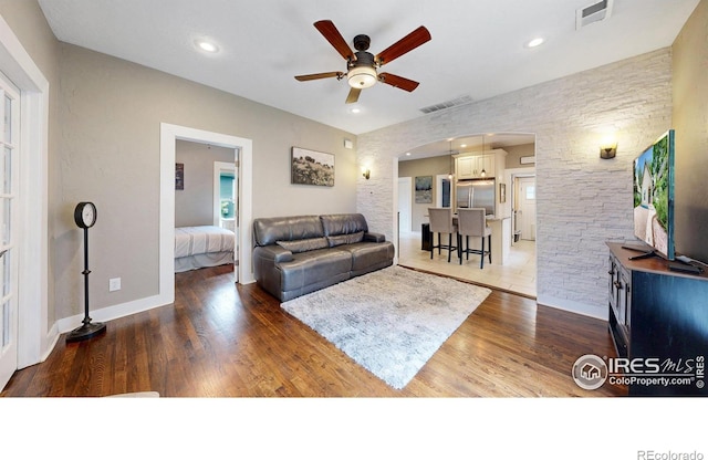 904 N Jefferson Ave, Loveland, CO 80537 - living area featuring arched walkways, a ceiling fan, wood finished floors, recessed lighting, and baseboards