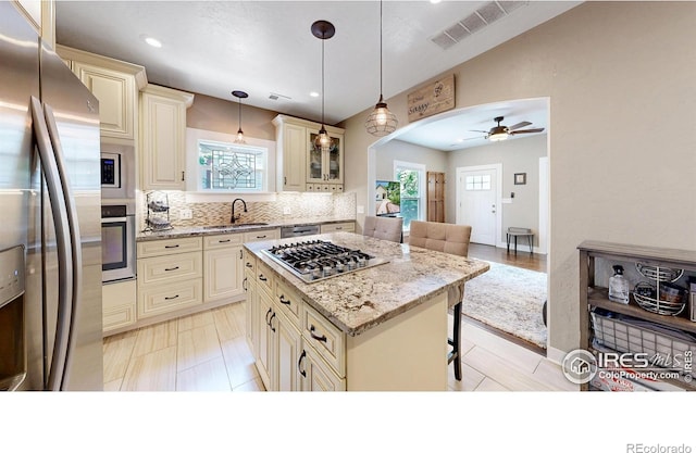 904 N Jefferson Ave, Loveland, CO 80537 - kitchen featuring cream cabinets, stainless steel appliances, a sink, and recessed lighting