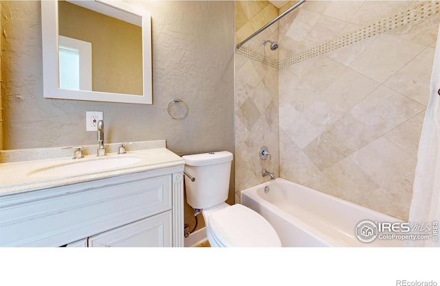 904 N Jefferson Ave, Loveland, CO 80537 - full bathroom with shower / tub combo, toilet, a textured wall, and vanity
