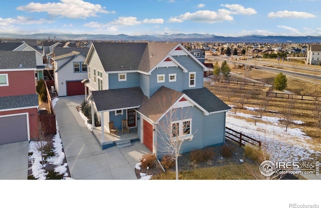1958 Autumn Moon Dr, Windsor, CO 80550 - view of front facade with concrete driveway, an attached garage, a residential view, a shingled roof, and a mountain view