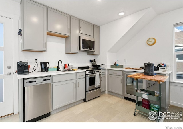 1958 Autumn Moon Dr, Windsor, CO 80550 - kitchen featuring stainless steel appliances, gray cabinetry, beverage cooler, light countertops, and a sink