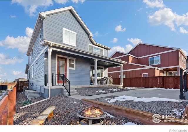 1958 Autumn Moon Dr, Windsor, CO 80550 - view of front of property with a fire pit, a porch, and central AC